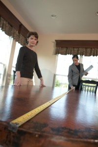 Image of people measuring a table