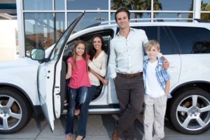 Family in front of car